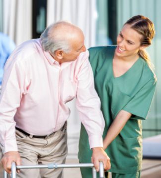 elderly-man-walker-female-caregiver elderly man with walker and female caregiver